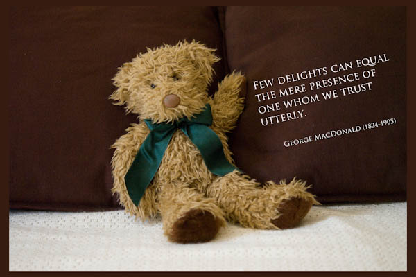 teddy bear on a settee with a quote about trust by George MacDonald
