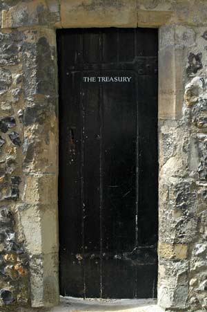 Door set in stone wall with name Treasury on door