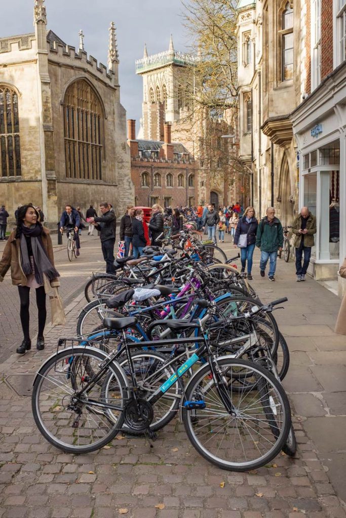 Bicycles parked in a line on the street in Cambridge near St Johns College